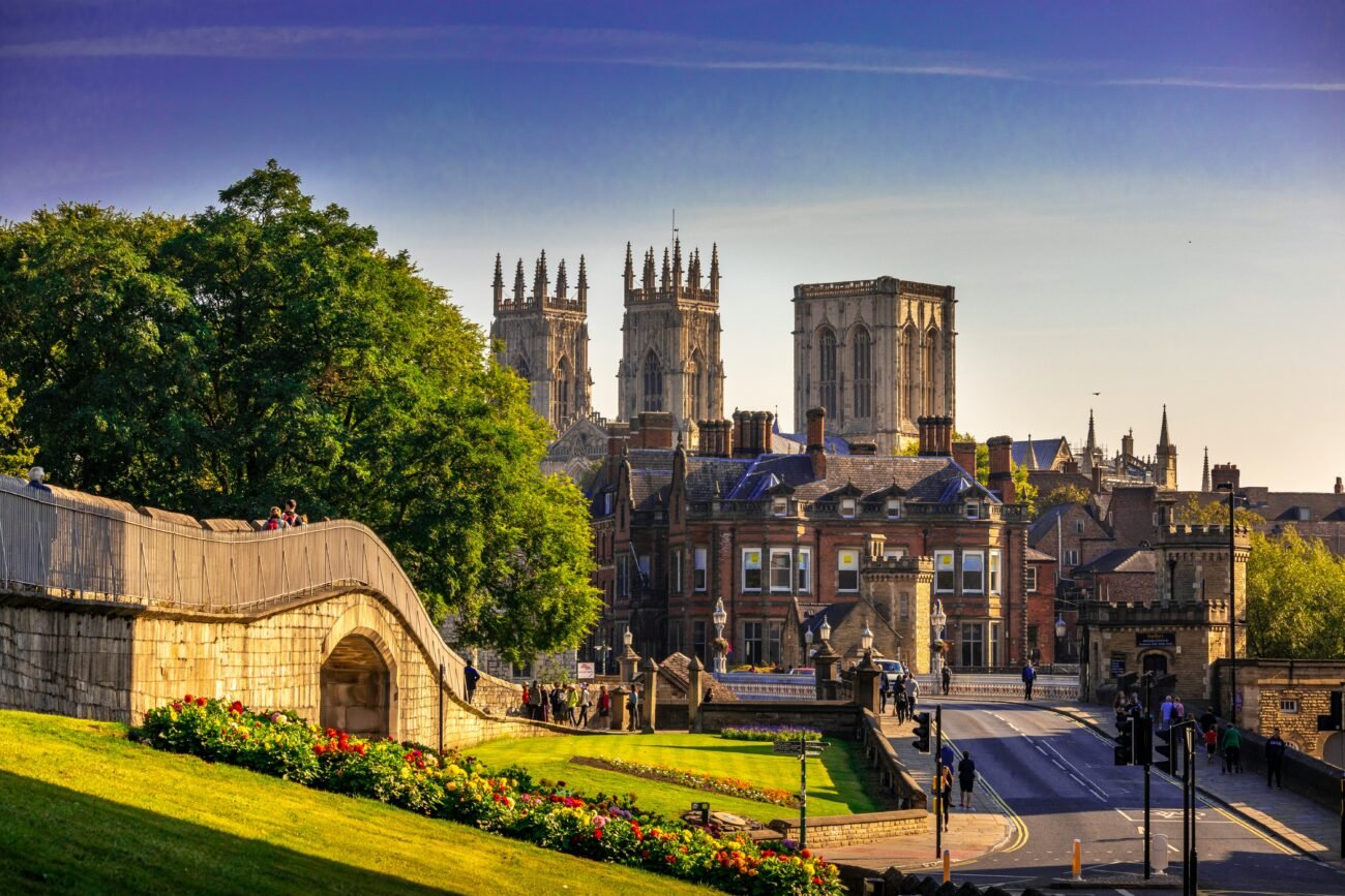 View of York Minster with surrounding buildings and greenery, illustrating the scenic backdrop for travelers using Manchester Airport Taxi Transfer services.