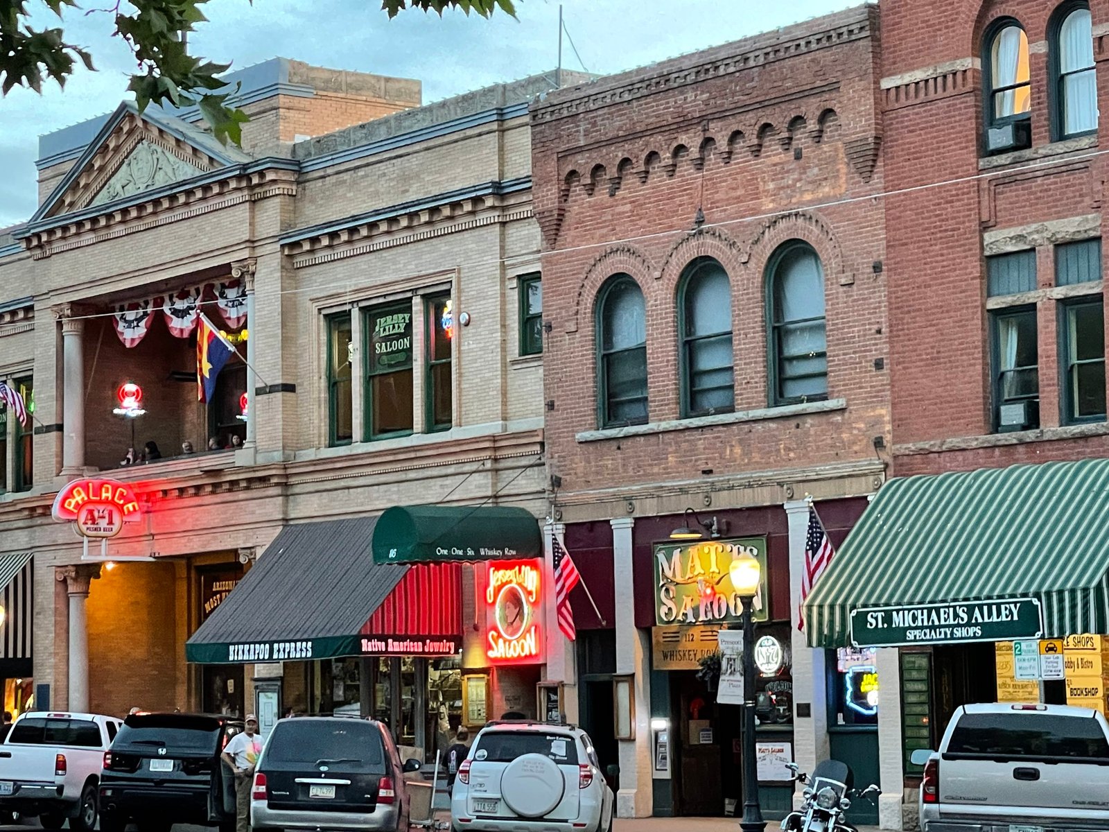 Historic Whiskey Row saloons and shops with neon signs at dusk - Manchester Airport Taxi Transfer - Manchester Airport Taxi Transfer