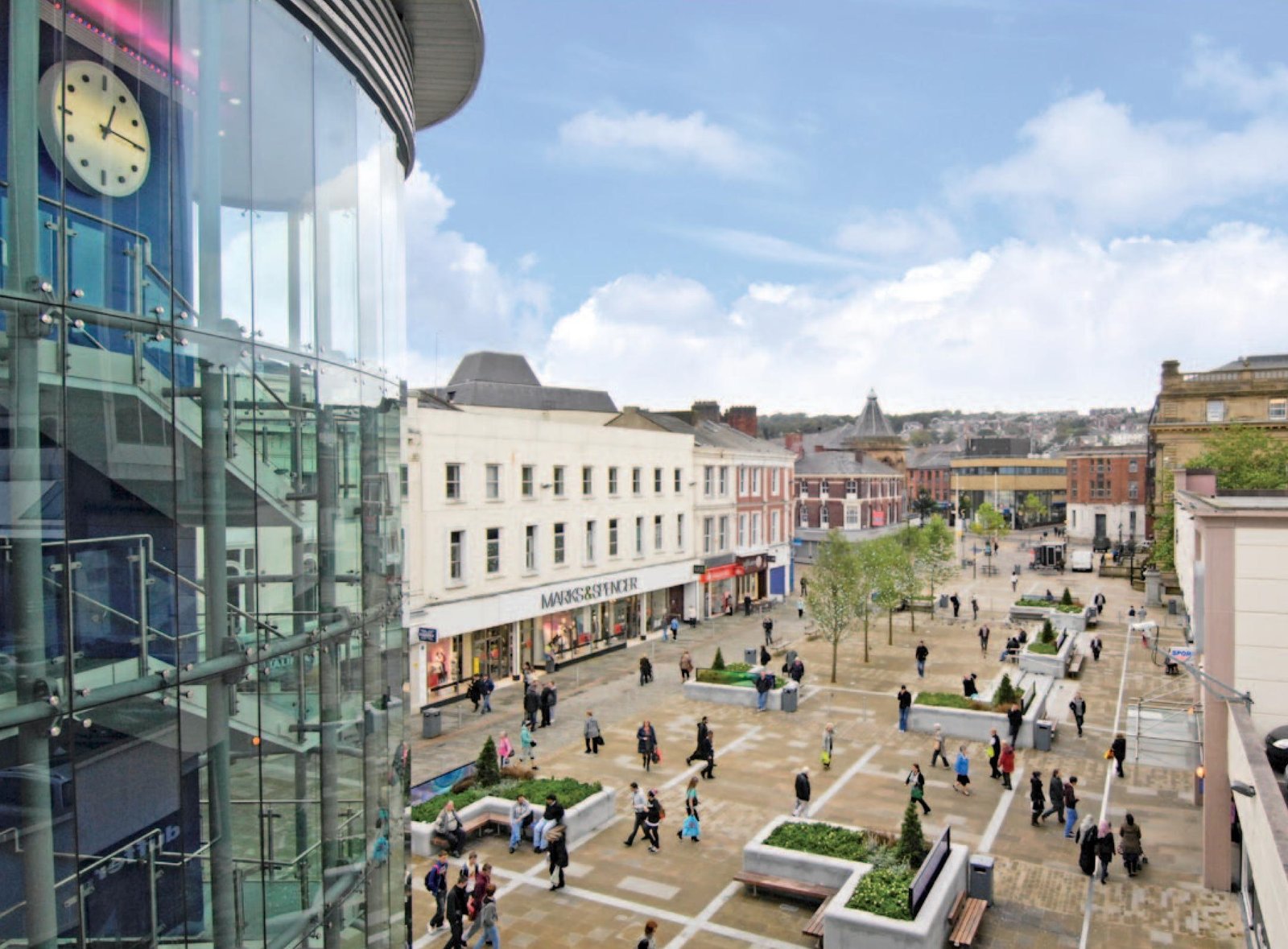 Marks and Spencer on busy UK town centre shopping square aerial view - Manchester Airport Taxi Transfer - Manchester Airport Taxi Transfer