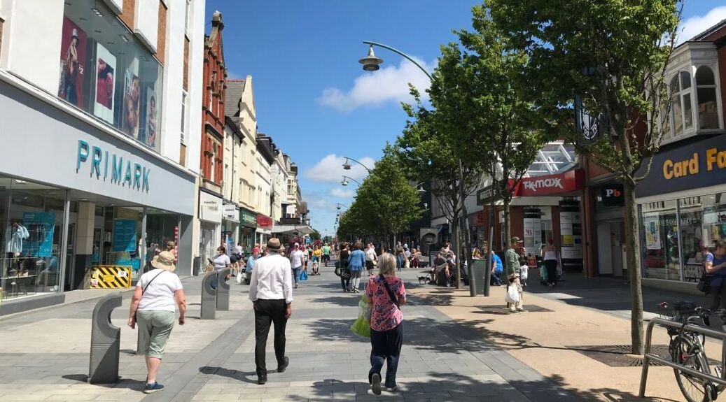 Southport high street with Primark, TK Maxx, and shoppers on a sunny day. - Manchester Airport Taxi Transfer - Manchester Airport Taxi Transfer