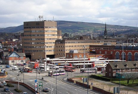 Rochdale town centre bus station with office buildings and hills in the background. - Manchester Airport Taxi Transfer - Manchester Airport Taxi Transfer