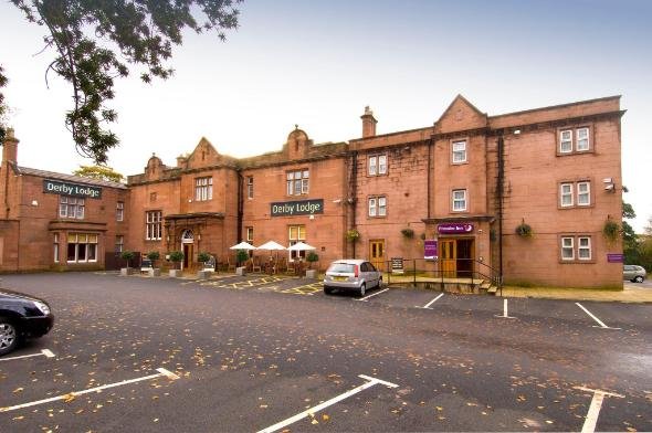 Derby Lodge Premier Inn red sandstone hotel exterior - Manchester Airport Taxi Transfer - Manchester Airport Taxi Transfer