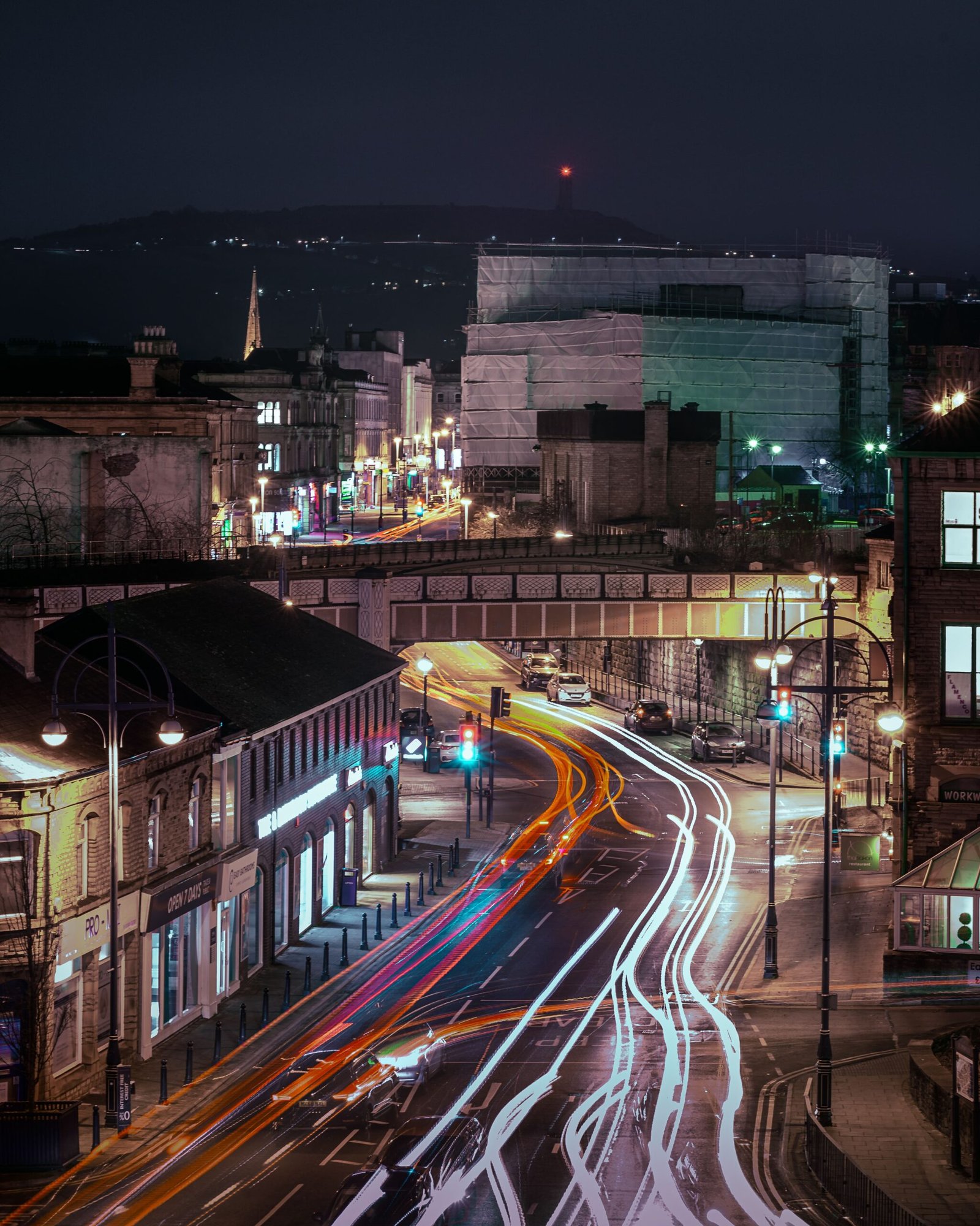 UK town centre night long exposure with colourful car light trails - Manchester Airport Taxi Transfer - Manchester Airport Taxi Transfer